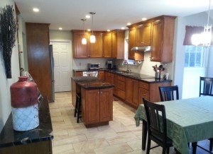 Open style kitchen with new flooring and cabinetry