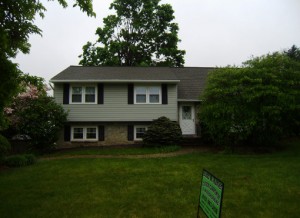 Exterior of home after new gray siding is installed